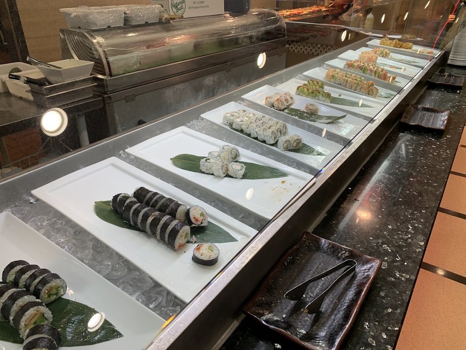 Buffet trays with seafood and sushi selections.